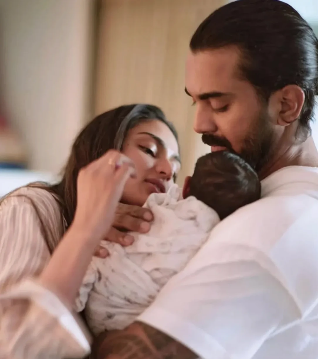 Athiya-Shetty-and-KL-Rahul-with-their-daughter.webp