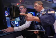 Dow tumbles after hitting record high, while Broadcom latest to fuel AI bubble fears