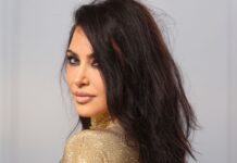 Kim Kardashian struggles to walk in skintight dress and towering heels at Oscars bash