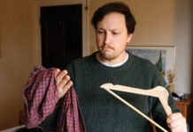 Man Torn Over Which Shirt Worthy Of Wooden Hanger