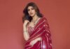 Sreeleela’s ruby red georgette sari is cut through with lines of mirror work