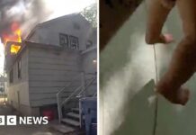 Police officer catches baby dropped from window of burning home
