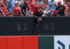 Reds fan has strange defense for dangling child over wall