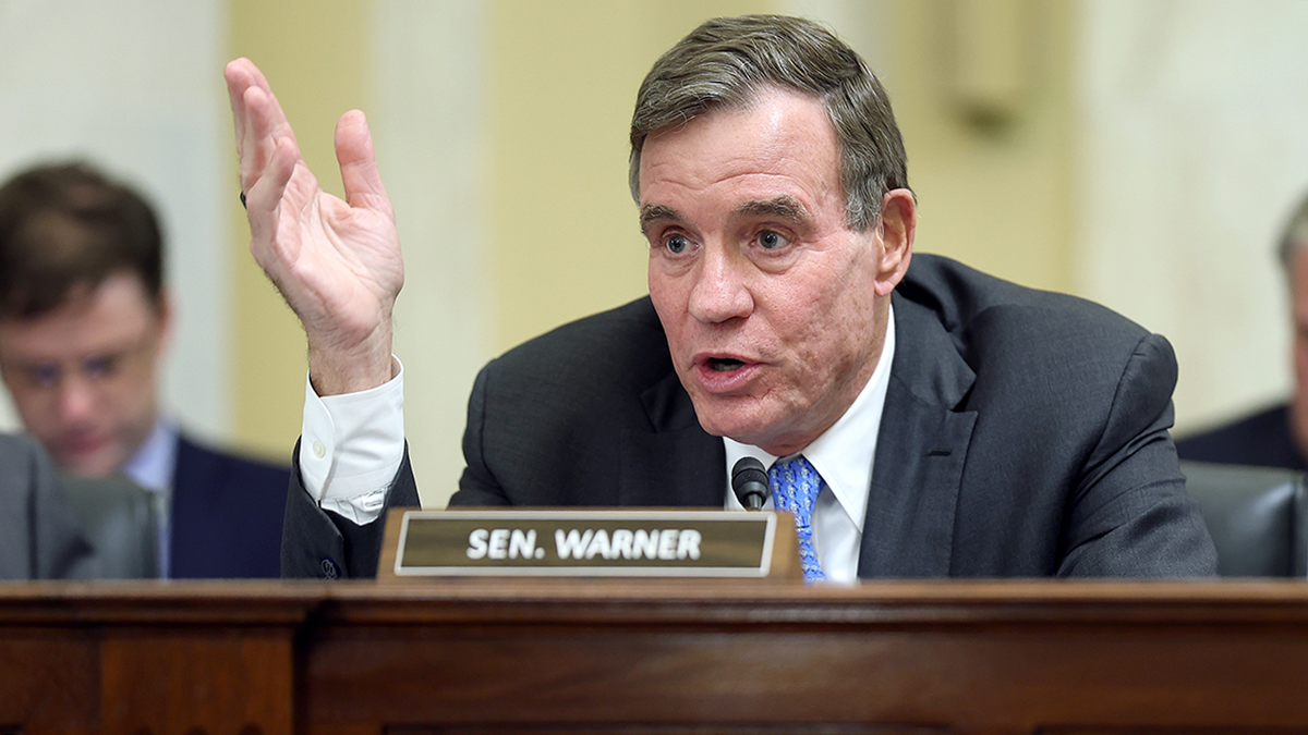 mark-warner-questions-witness-in-hearing.png