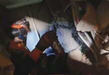 Rescuers in Venezuela race to save security guard trapped under building