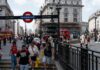 Man in shades and hat steps up to sing with busker, then people realise who it is