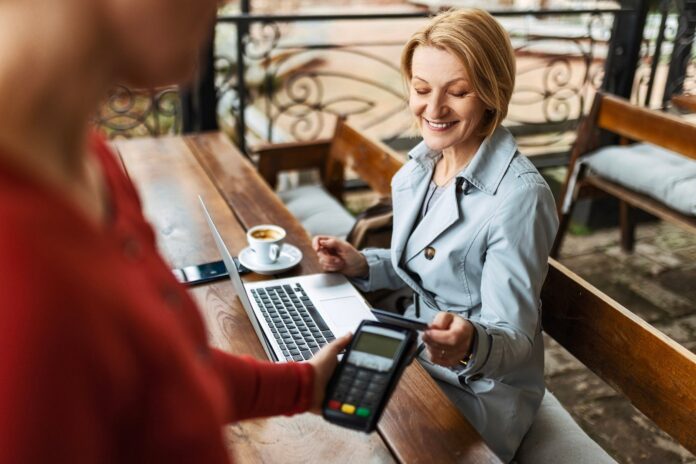 Business-woman-working-with-laptop-in-coffee-shop-and-paying-with-credit-card_Zorica-Nastasic.jpg