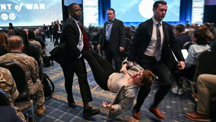 protestor-carried-out.jpg